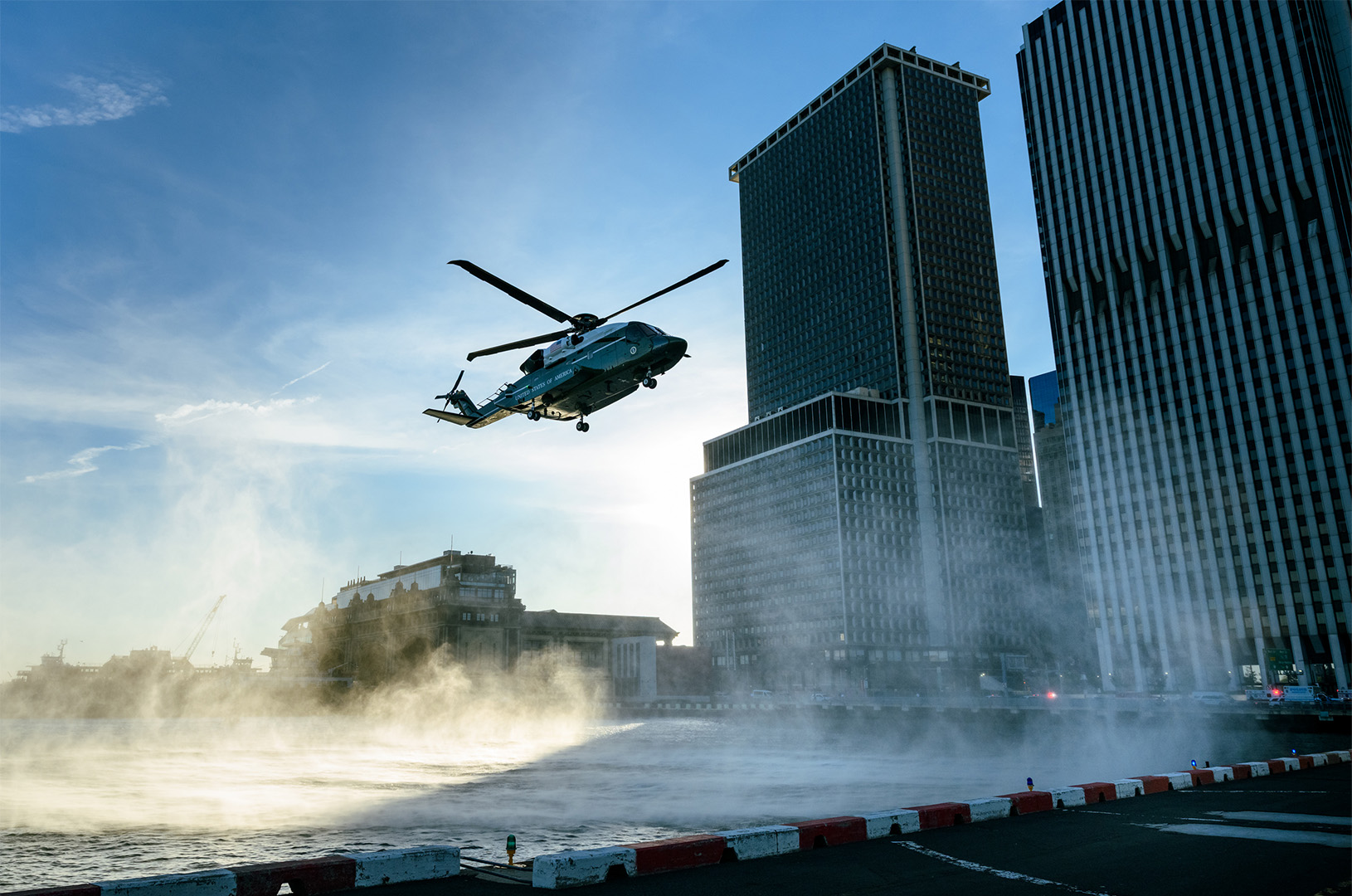 Military helicopter soaring through city skies