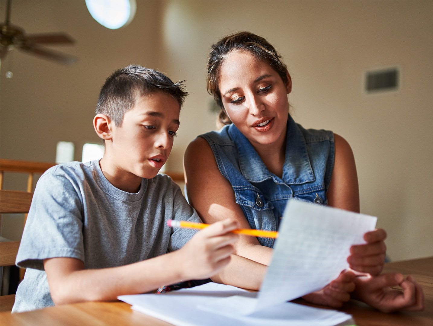 Mother and son study together at home
